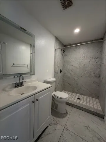 a bedroom with furniture and a flat screen tv