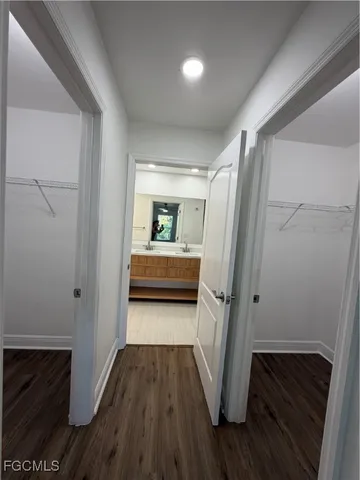 a bathroom with a double vanity sink mirror and shower