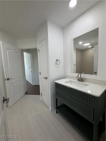 a bathroom with a sink and a mirror
