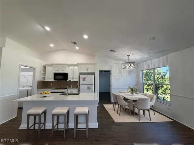 a view of kitchen with furniture and wooden floor