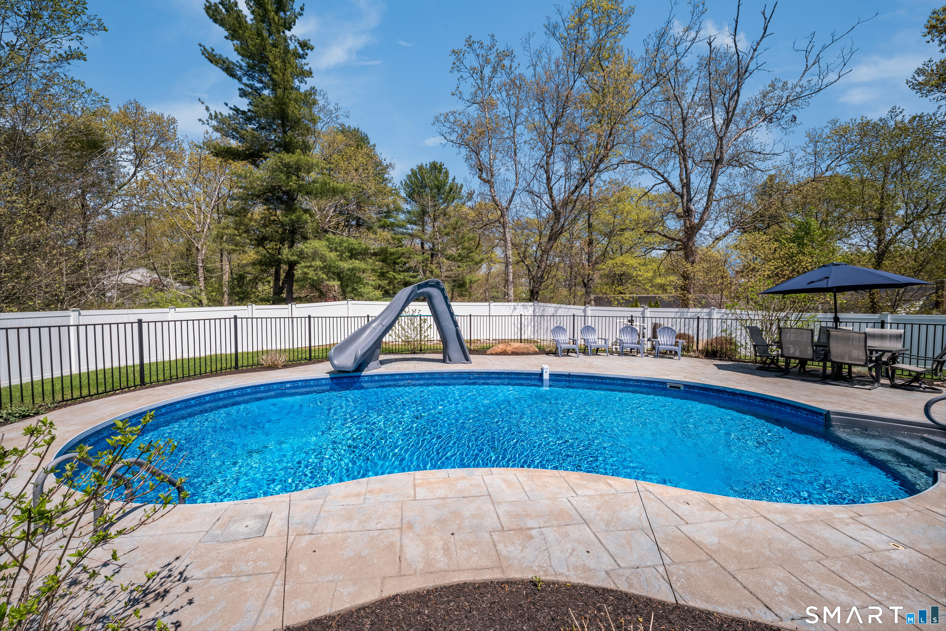 9 Sunset Ridge Drive Guilford, CT 06437 - Photo 35 of 40 a view of a swimming pool with a lounge chair