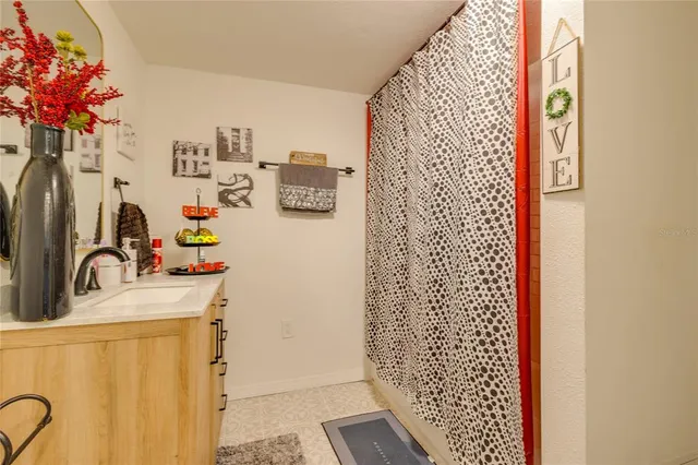 a bathroom with a sink and a shower curtain