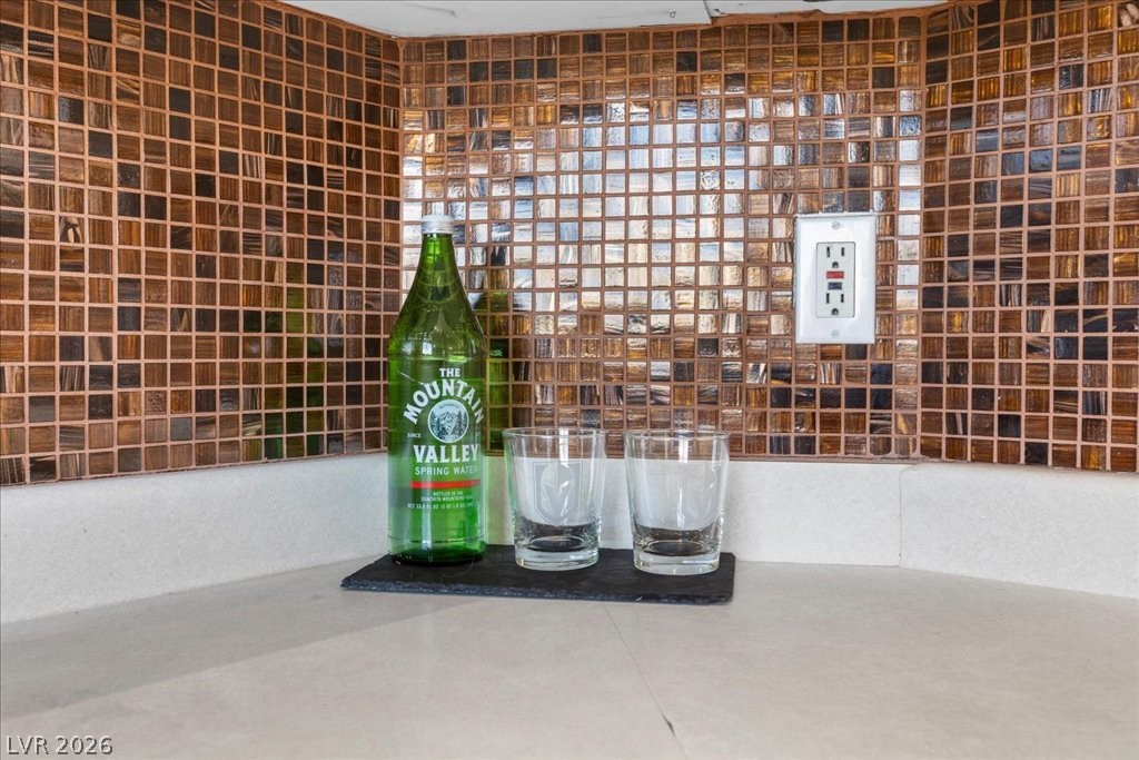 1881 West Alexander Road, Unit 1037 North Las Vegas, NV 89032 - Photo 6 of 31 Reflective mosaic tile backsplash complements the smooth, light-toned countertop.