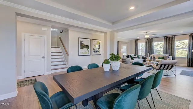 a kitchen with a dining table chairs refrigerator and cabinets