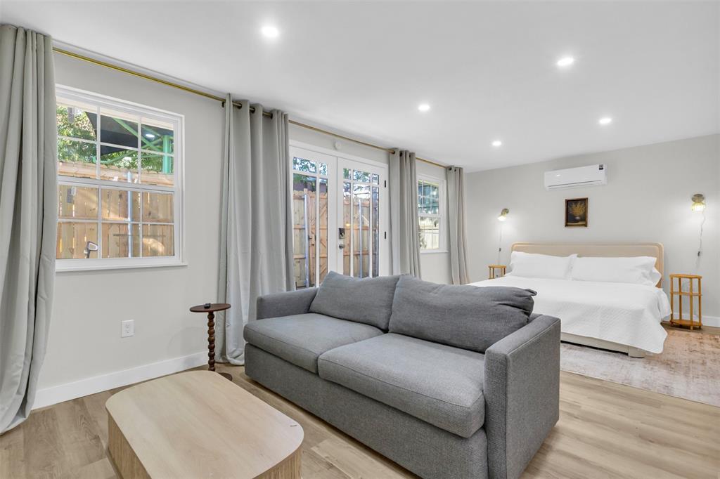 4121 Junius Street, Unit B Dallas, TX 75246 - Photo 9 of 32 Open-concept space featuring wood-finish flooring, recessed lighting, and white walls