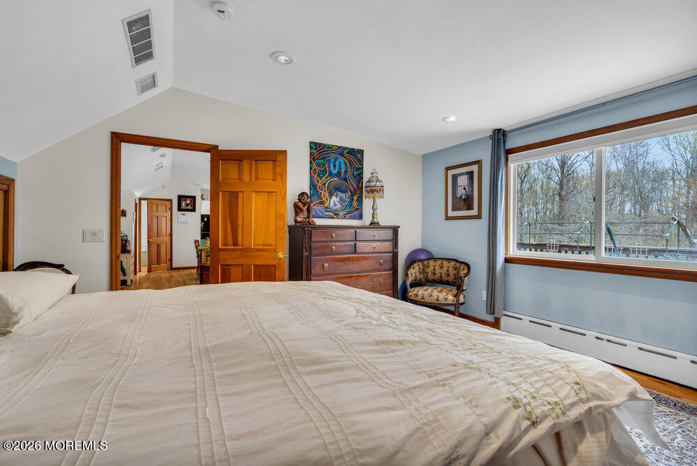 34 State Route Colts Neck, NJ 07722 - Photo 8 of 40 a bedroom with a bed and a large window