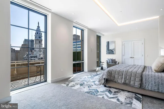 a bedroom with a large bed and a window