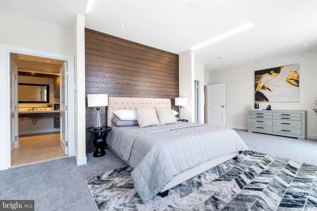 a bedroom with a bed and a painting on the wall