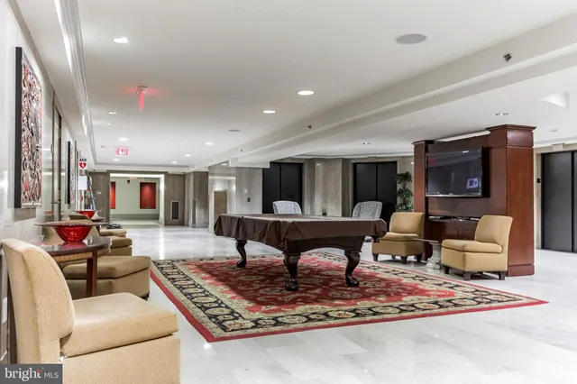a living room with furniture and a rug