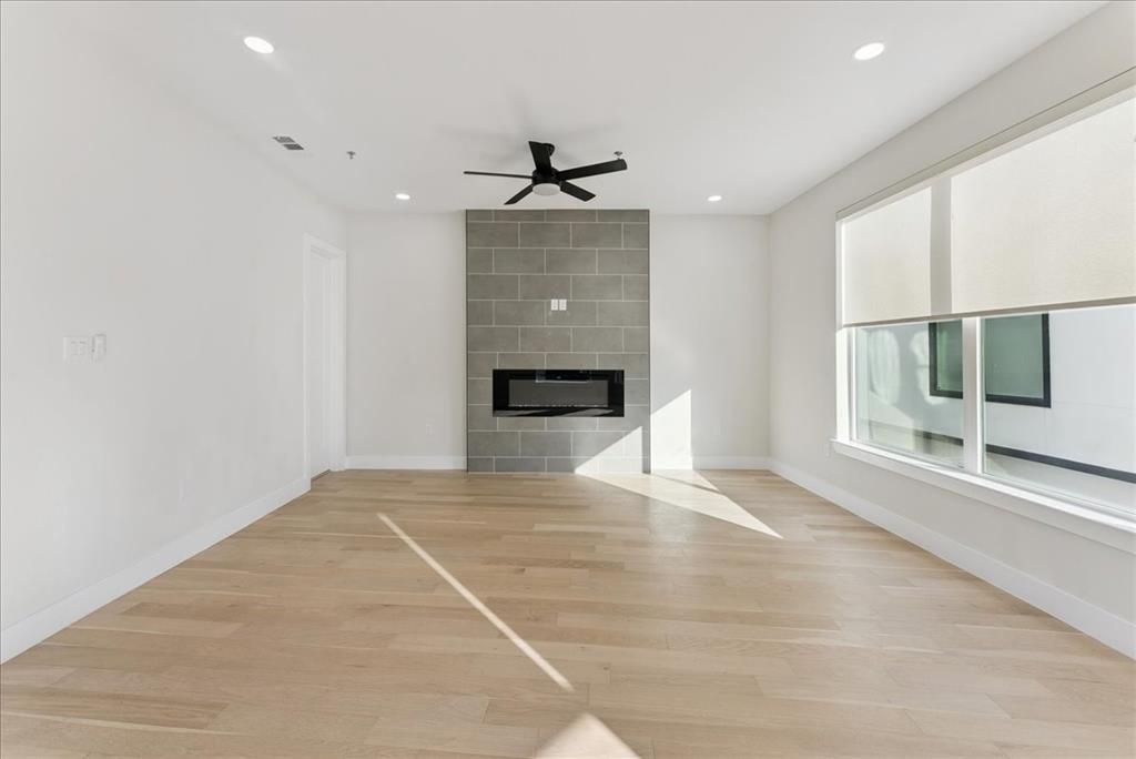 1512 Seegar Street, Unit 101 Dallas, TX 75215 - Photo 11 of 31 an empty room with windows and fireplace