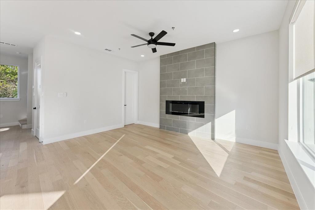 1512 Seegar Street, Unit 101 Dallas, TX 75215 - Photo 12 of 31 an empty room with windows and ceiling fan