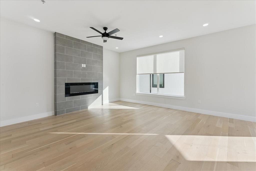 1512 Seegar Street, Unit 101 Dallas, TX 75215 - Photo 14 of 31 an empty room with windows and fireplace