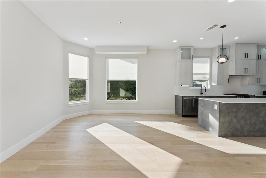 1512 Seegar Street, Unit 101 Dallas, TX 75215 - Photo 16 of 31 a kitchen with granite countertop a stove a sink and a counter top space