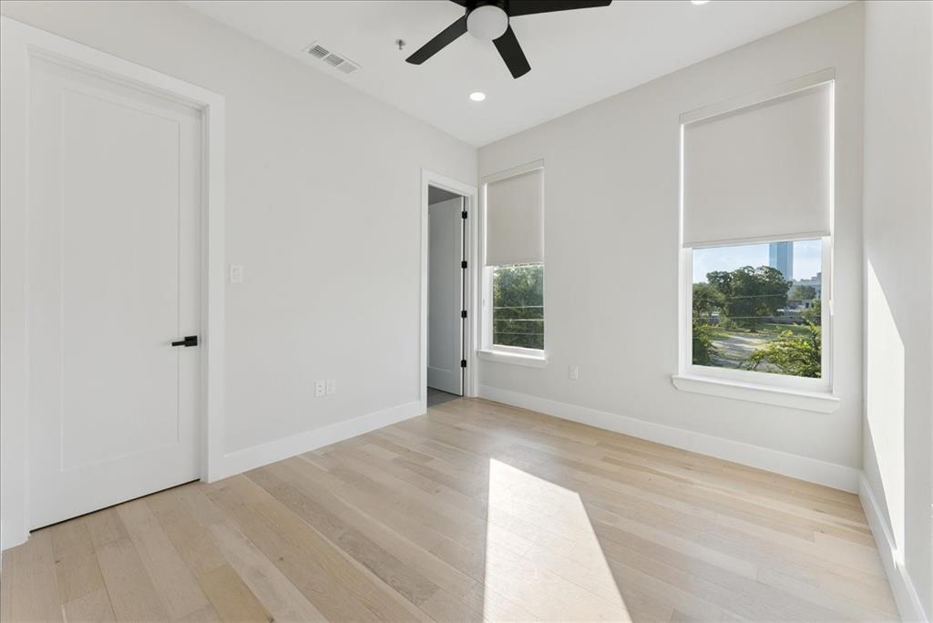 1512 Seegar Street, Unit 101 Dallas, TX 75215 - Photo 18 of 31 wooden floor in an empty room with a window