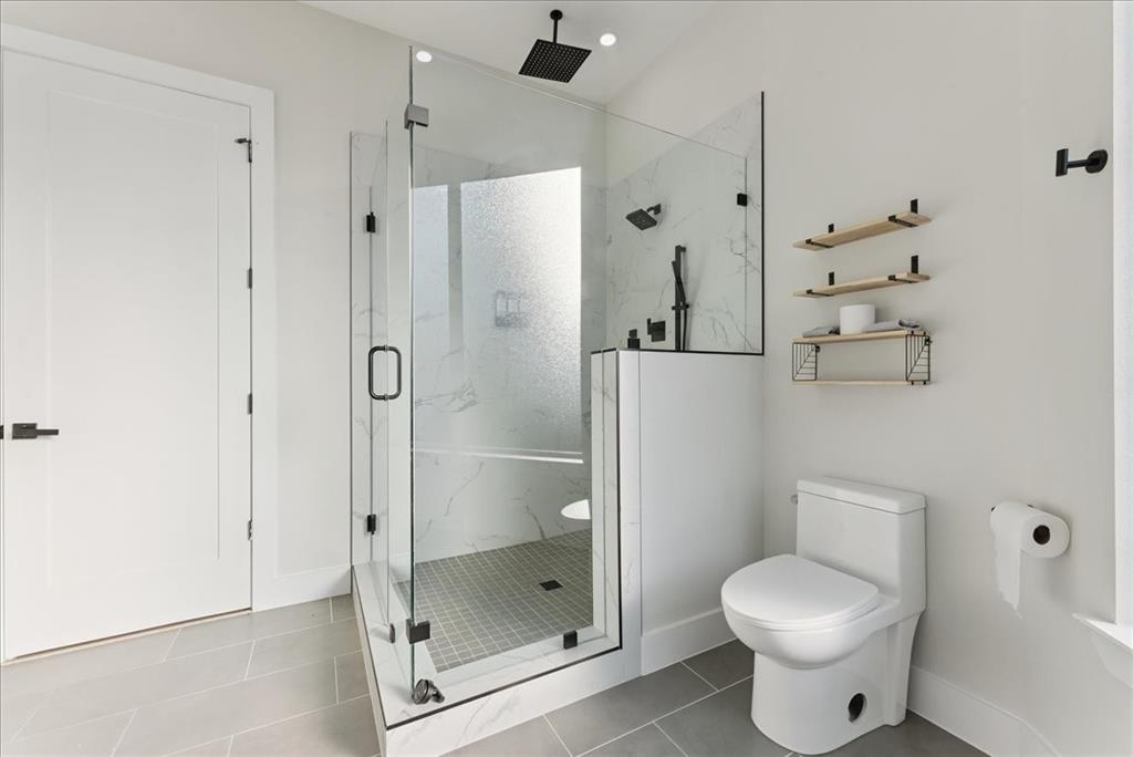 1512 Seegar Street, Unit 101 Dallas, TX 75215 - Photo 24 of 31 a bathroom with a shower and a toilet