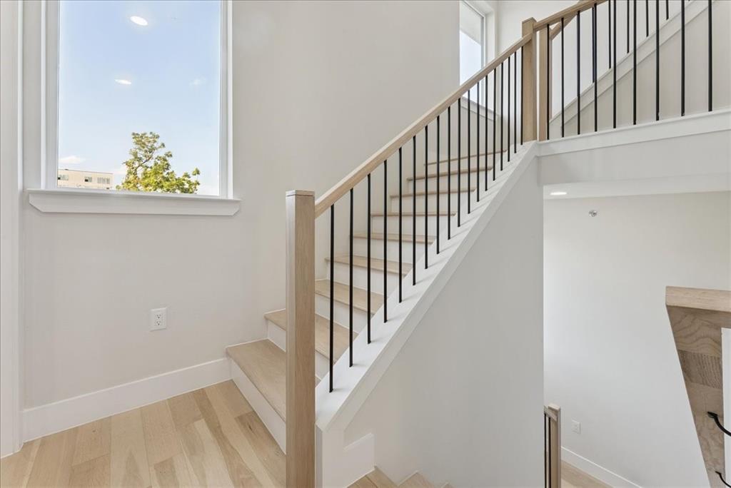 1512 Seegar Street, Unit 101 Dallas, TX 75215 - Photo 26 of 31 a view of staircase with railing and a rug