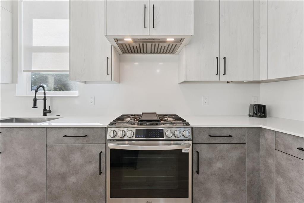 1512 Seegar Street, Unit 101 Dallas, TX 75215 - Photo 5 of 31 a stove top oven sitting inside of a kitchen