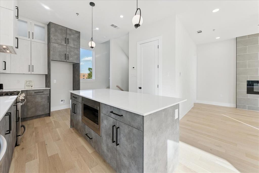 1512 Seegar Street, Unit 101 Dallas, TX 75215 - Photo 9 of 31 a kitchen with a sink appliances and cabinets