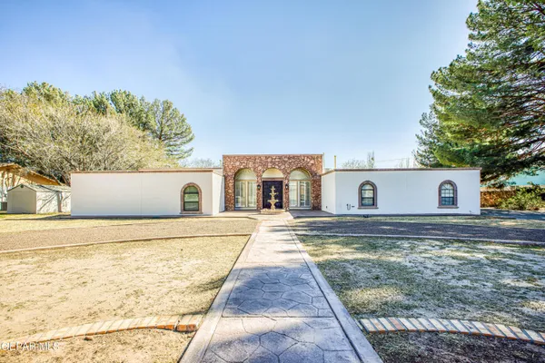 a view of a white house with a yard and garage