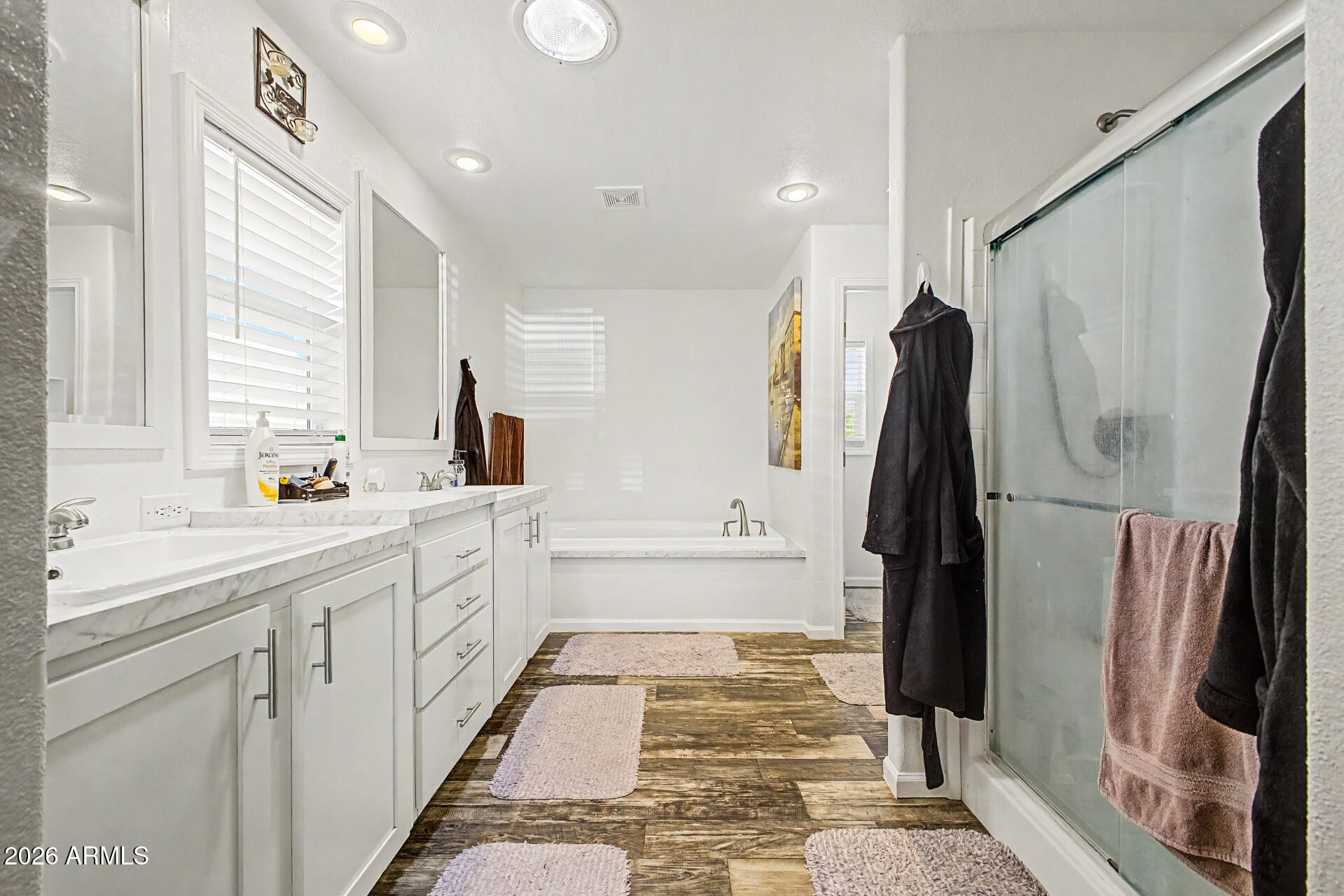 22417 West Dove Valley Road Wittmann, AZ 85361 - Photo 20 of 53 a bathroom with a double vanity sink and a bathtub