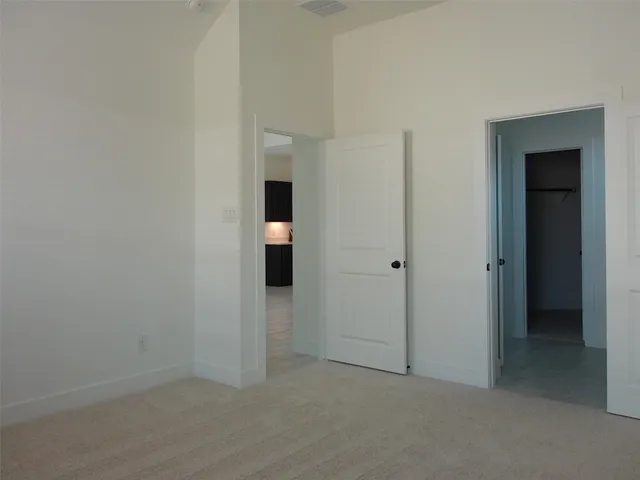 an empty room with closet and mirror