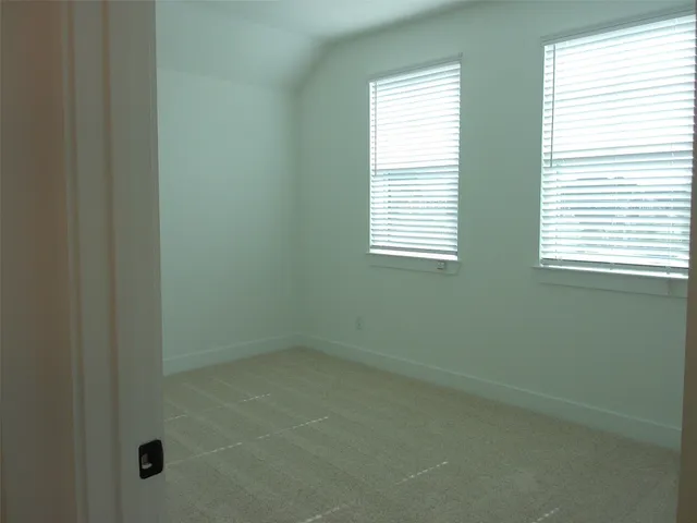 a view of an empty room with a mirror