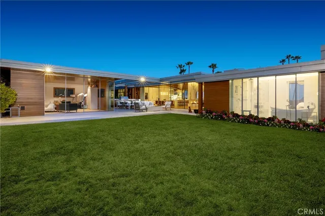a front view of a house with a yard fire pit and outdoor seating