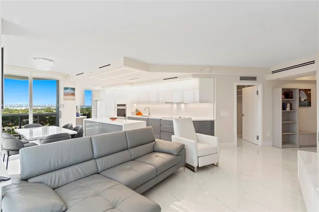 a large kitchen with kitchen island a large window in it