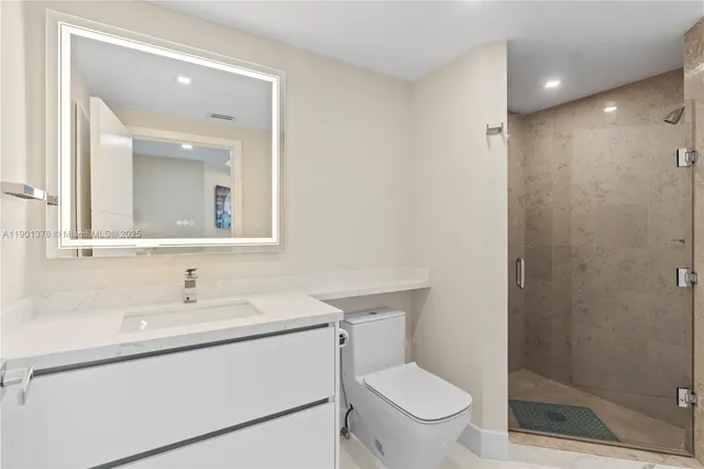 a view of a livingroom with furniture and floor to ceiling window