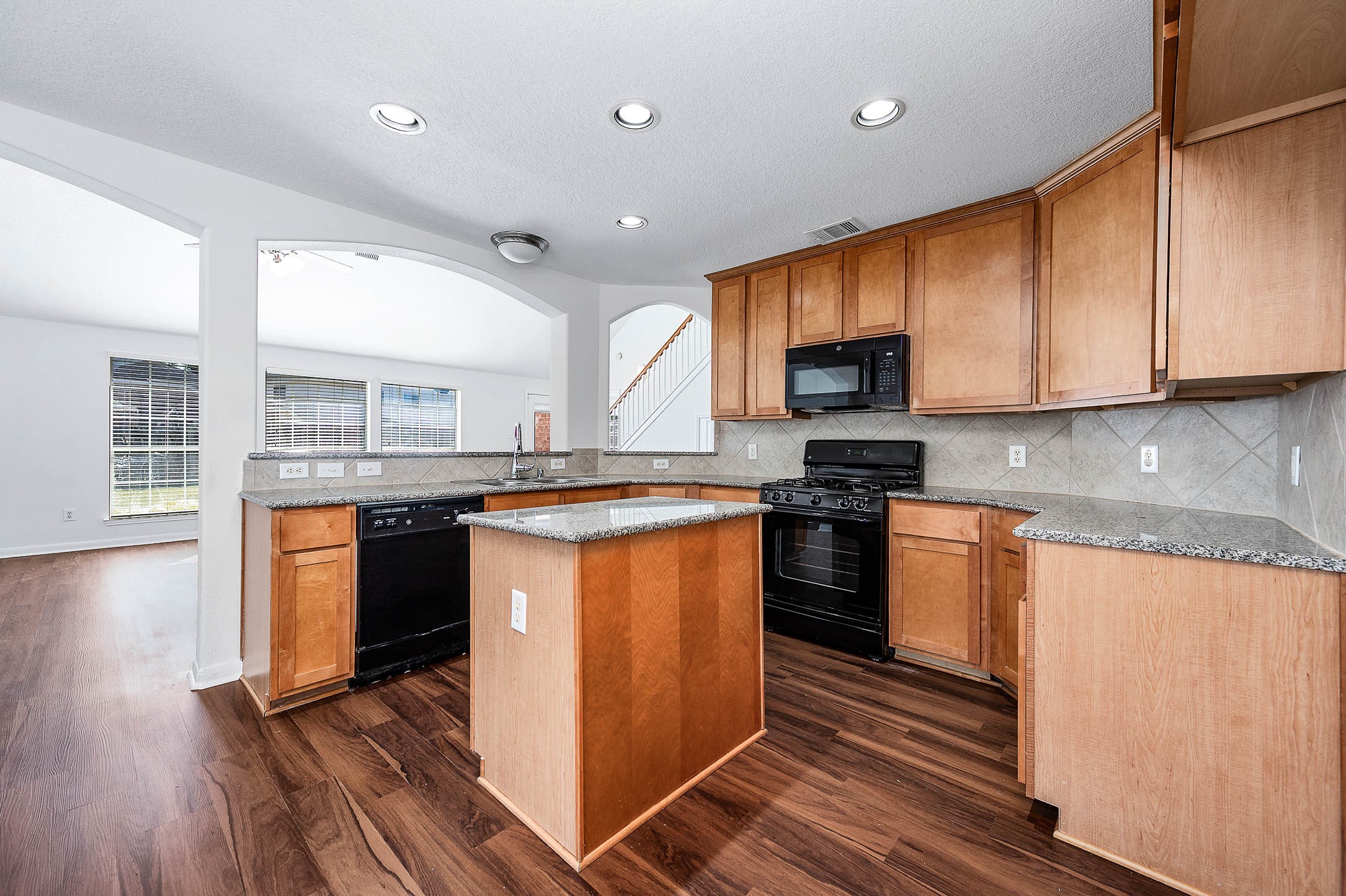 13402 Timber Oak Court Rosharon, TX 77583 - Photo 11 of 34 a kitchen with stainless steel appliances granite countertop a stove a sink and a microwave