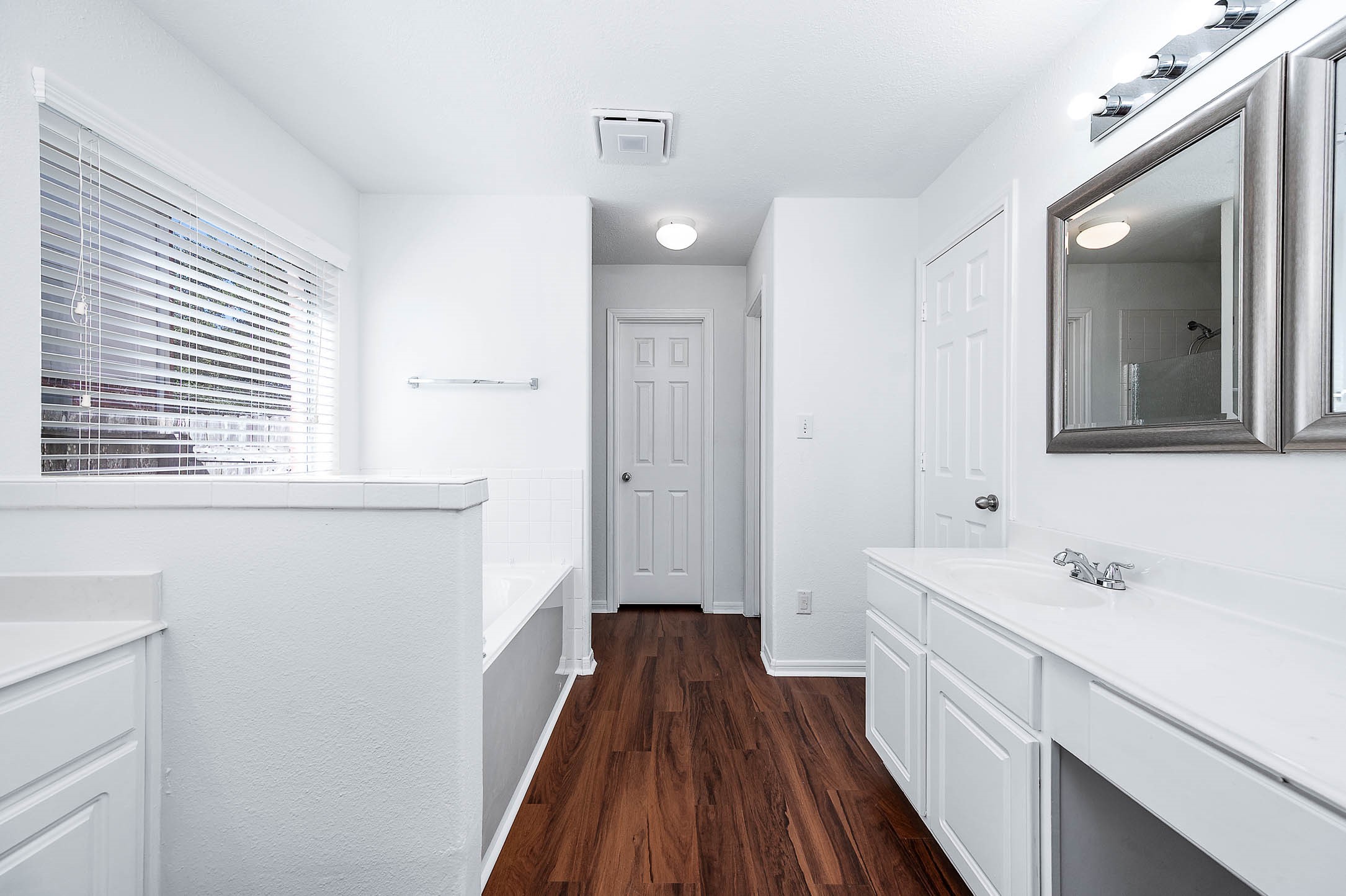 13402 Timber Oak Court Rosharon, TX 77583 - Photo 18 of 34 a bathroom with a sink a large mirror a vanity and a shower
