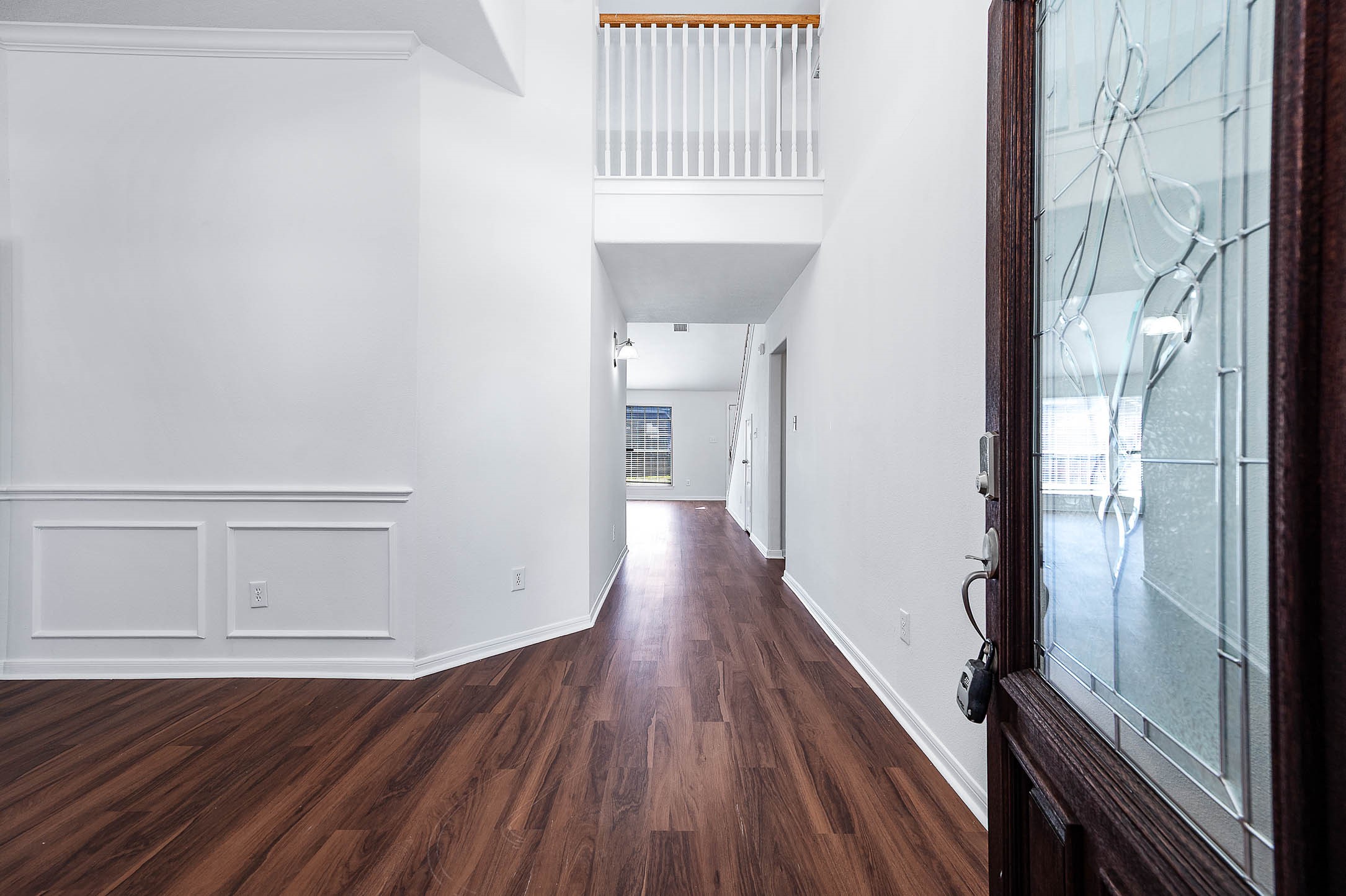 13402 Timber Oak Court Rosharon, TX 77583 - Photo 2 of 34 a view of a hallway with wooden floor and staircase