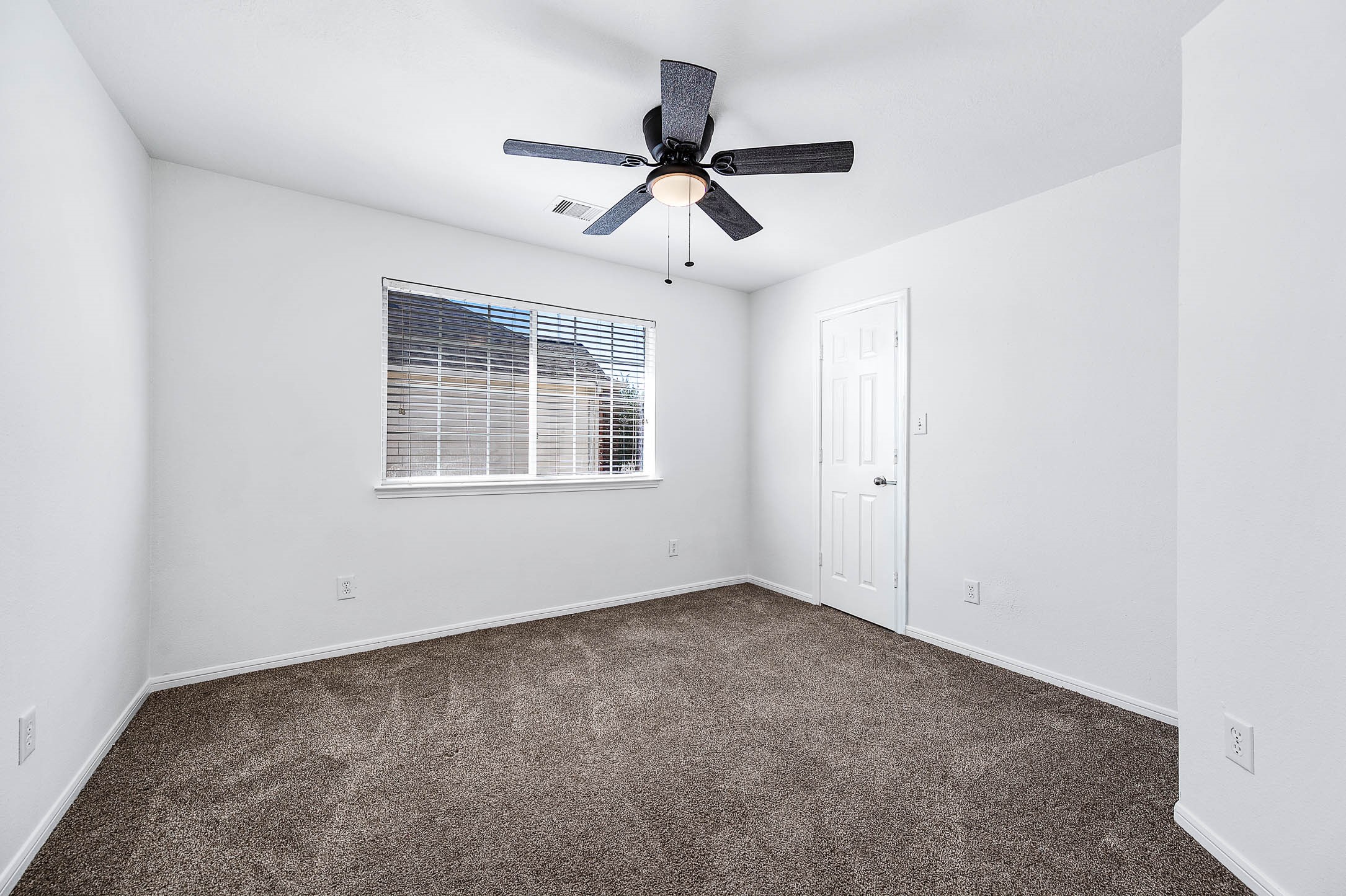 13402 Timber Oak Court Rosharon, TX 77583 - Photo 27 of 34 an empty room with ceiling fan and windows