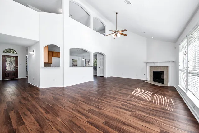 a view of a livingroom with wooden floor and fireplace