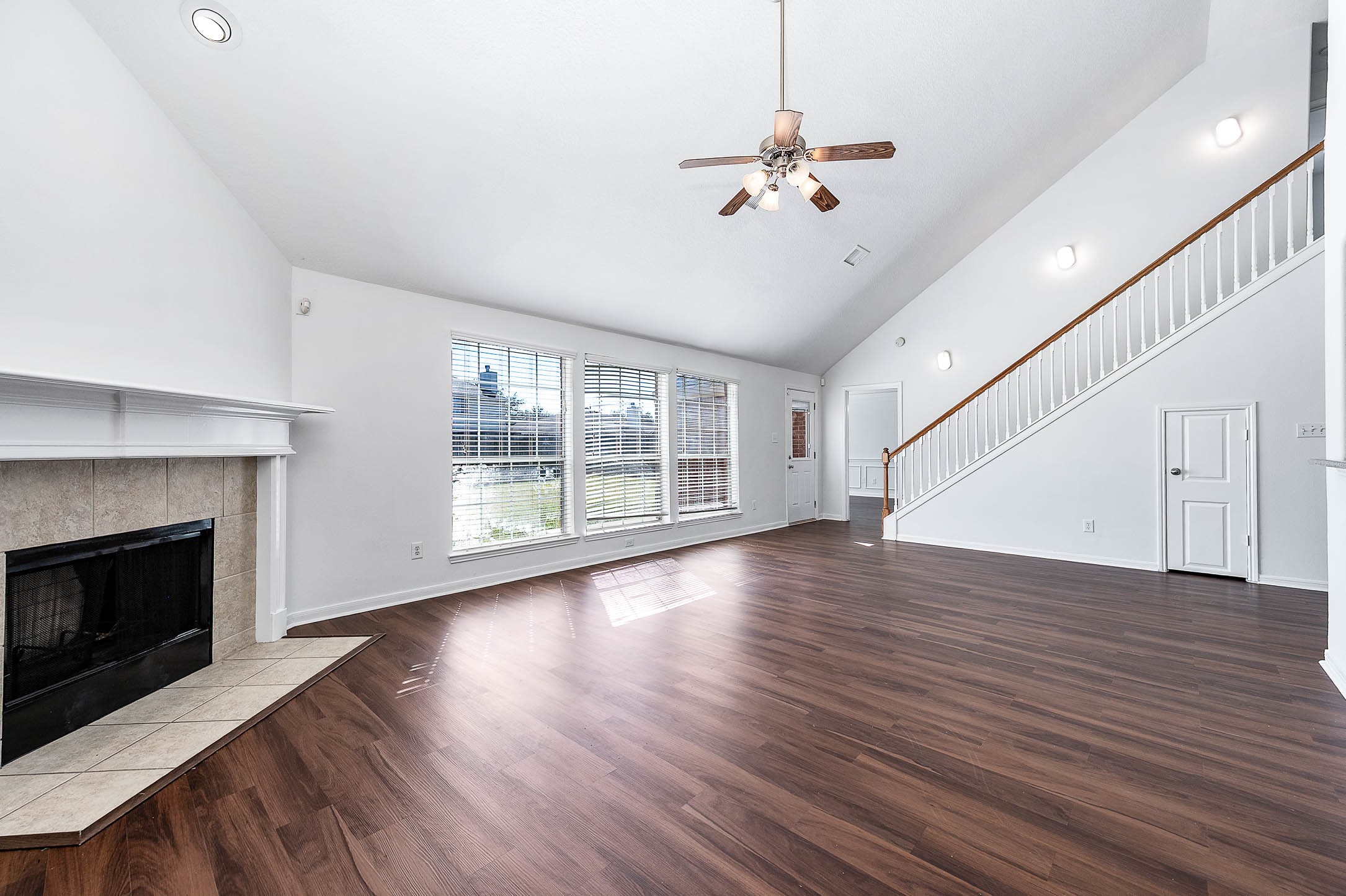 13402 Timber Oak Court Rosharon, TX 77583 - Photo 7 of 34 a view of an empty room with wooden floor and a fireplace
