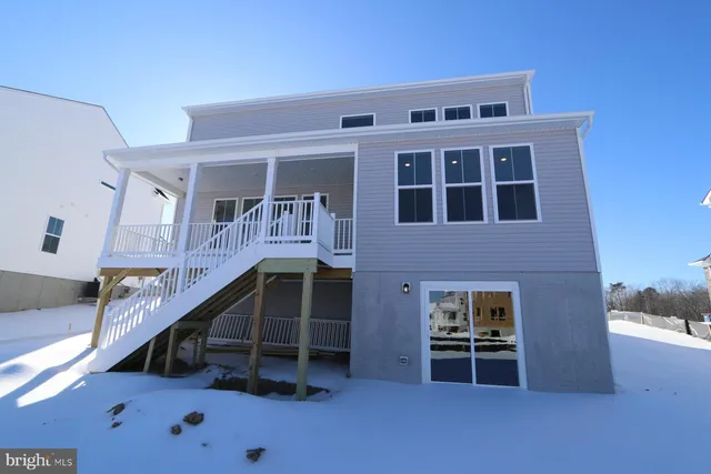 a view of house with roof deck and seating space