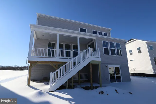 a view of front door of house with stairs