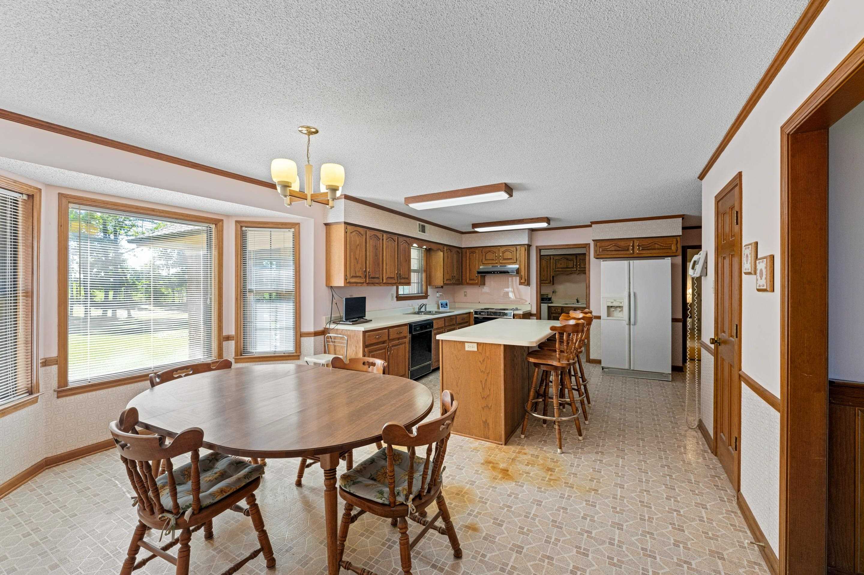 650 Blain Road Rossville, TN 38066 - Photo 10 of 26 With natural light pouring in, this kitchen combines style and practicality. Ample counters give plenty of workspace, and the pantry ensures organized storage. The eat-in area offers a cozy spot to enjoy meals while overlooking the spacious grounds.