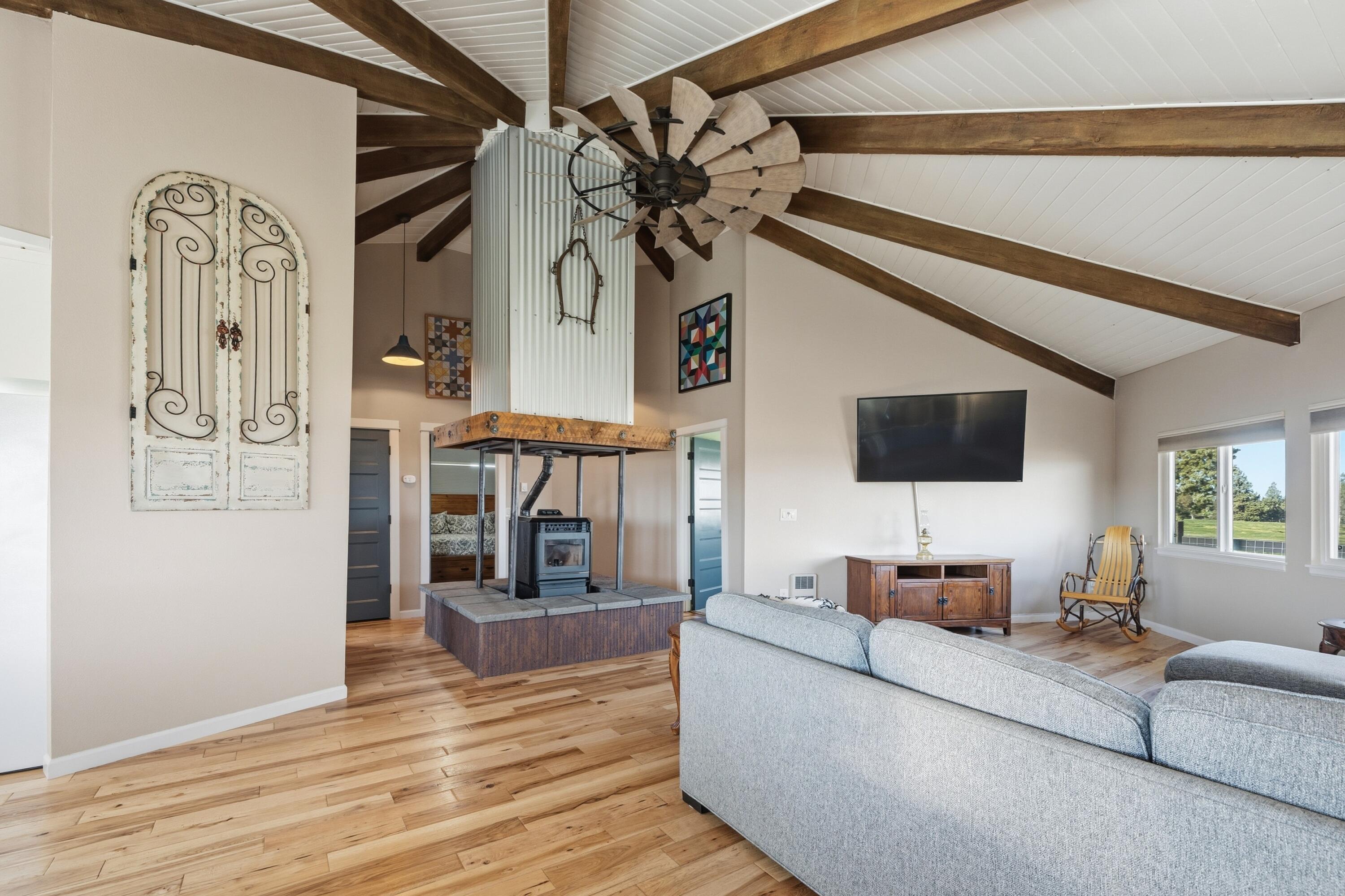 4074 Southwest Reif Road Powell Butte, OR 97753 - Photo 6 of 59 a living room with furniture and a wooden floor