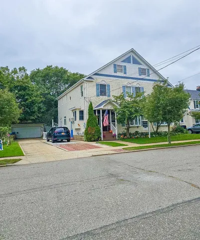 a front view of a house with a yard and a garage