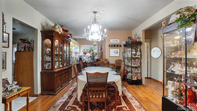 a view of a dining room with furniture a chandelier and wooden floor