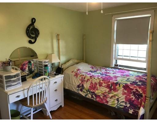 488 Delano Road Marion, MA 02738 - Photo 17 of 24 a bedroom with a bed and a chandelier