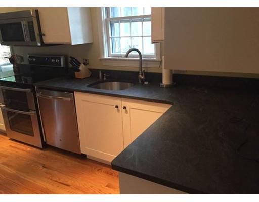 488 Delano Road Marion, MA 02738 - Photo 4 of 24 a kitchen with granite countertop white cabinets and black appliances