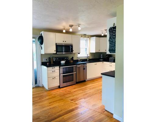 488 Delano Road Marion, MA 02738 - Photo 9 of 24 a kitchen with stainless steel appliances a stove top oven a sink a microwave and cabinets