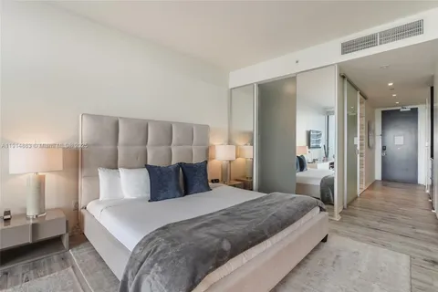 a bedroom with a bed and a lamp