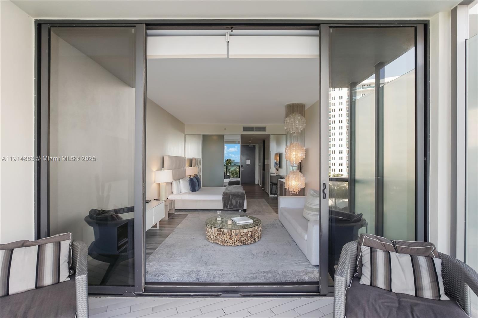 2201 Collins Avenue, Unit 523 Miami Beach, FL 33139 - Photo 16 of 18 a living room with furniture and a table