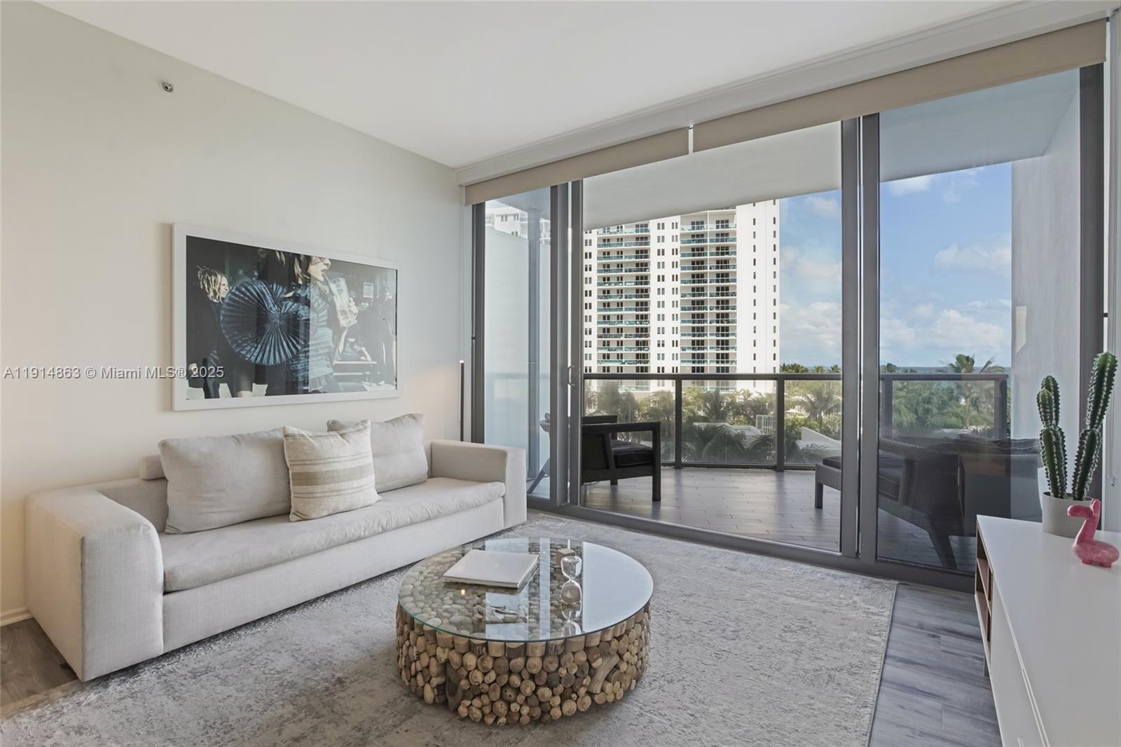 2201 Collins Avenue, Unit 523 Miami Beach, FL 33139 - Photo 3 of 18 a living room with furniture and a large window