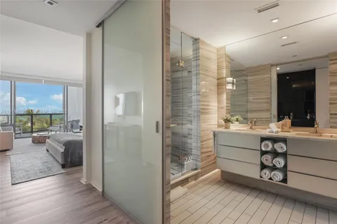 a bathroom with a sink mirror and a bath tub