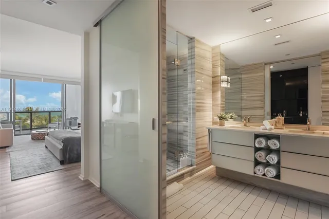 a bathroom with a sink mirror and a bath tub