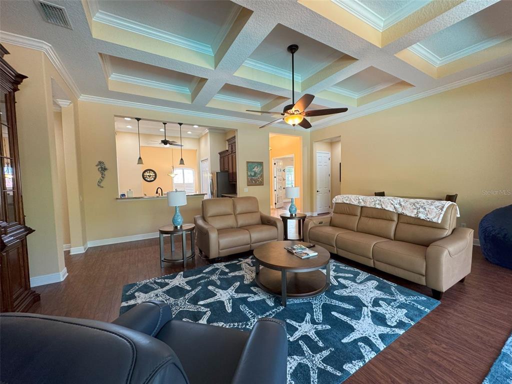 1024 West Beagle Run Loop Hernando, FL 34442 - Photo 10 of 44 a living room with furniture a rug and a chandelier